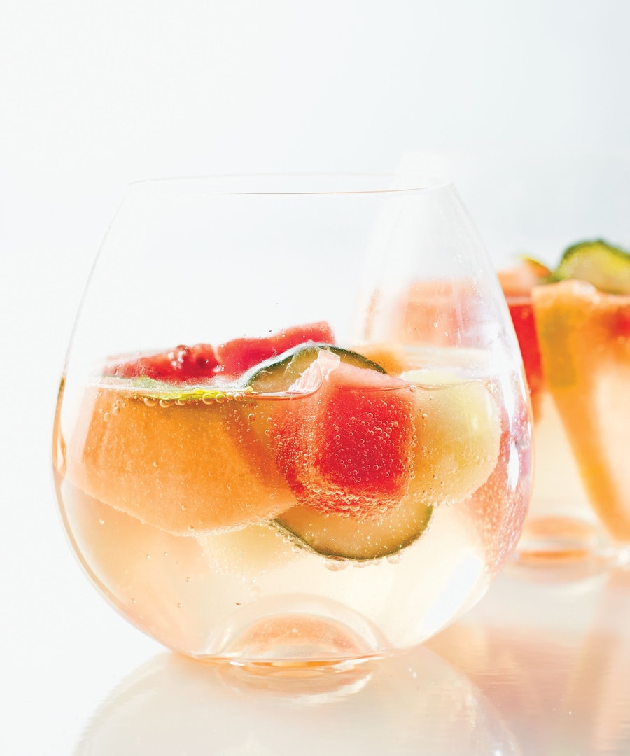 Piece of cut melon inside a glass of sparkling water