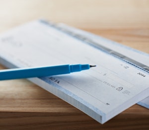 a pen sits on a checkbook
