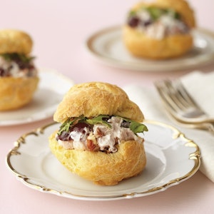 Chicken salad with pecans and grapes is served in cream puff bowls
