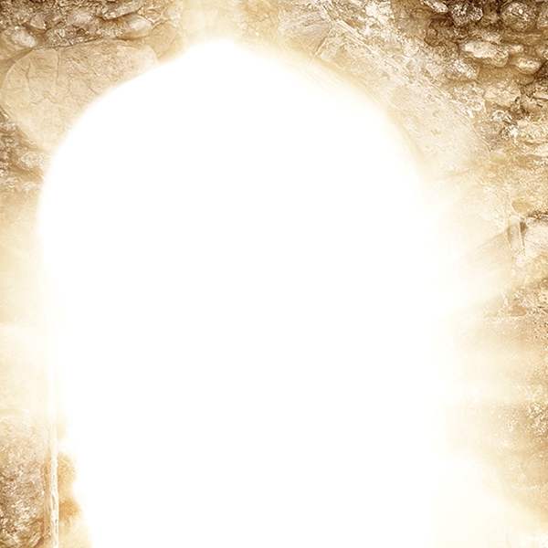 Light shines from an entrance to a cave.
