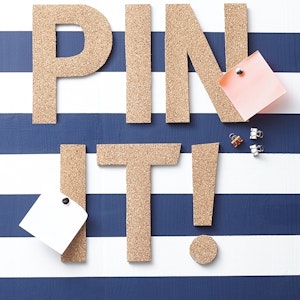 Cork letters spell out 'Pin it!'
