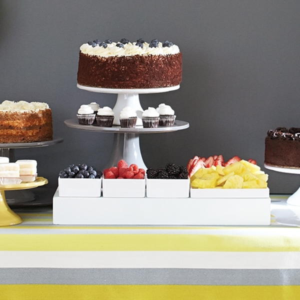 A spread of cakes, fruits and beverages and the Bible verse Jeremiah 1:15 is set for a yellow-and-gray-themed co-ed baby shower
