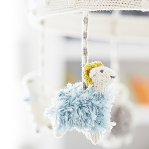 Plush animals dangle from a baby's mobile.
