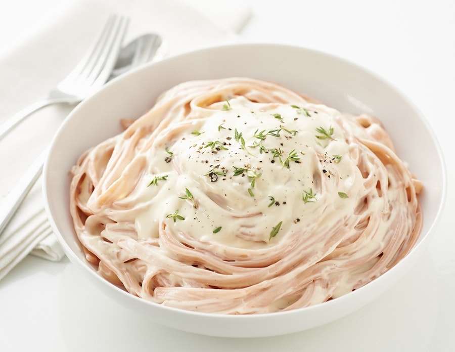 Tint pasta pink with red food coloring and serve it with delectable Alfredo Sauce.