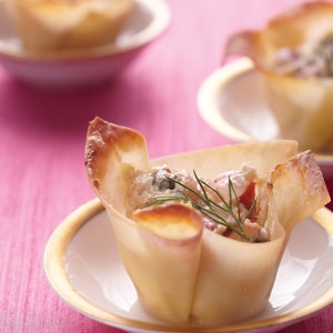Baked wonton cups cradle bite-sized tastes of savory smoked salmon. Display these beauties on trays set out for guests to help themselves or on pretty individual dishes.
