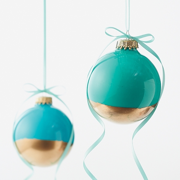 Color-dipped ornaments: Glass paint and spray paint embellish plain glass balls with color and shine. Add satin ribbon to these tree decorations. Gift one or nest a collection in a pretty box filled with shredded paper.
